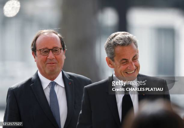 Former French president Francois Hollande and Former French president Nicolas Sarkozy attend a ceremony to mark the end of World War II at the Arc de...
