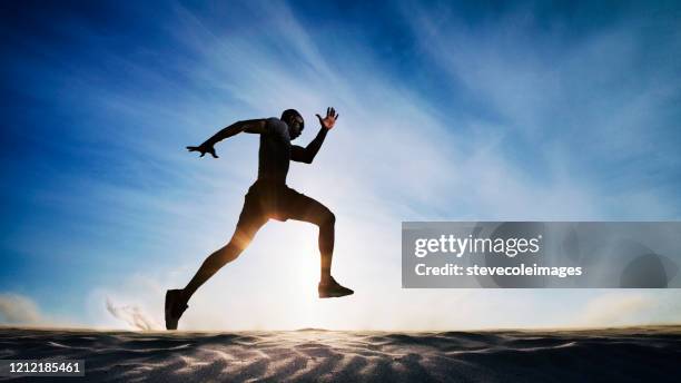 man running on sand dunes. - black male bodybuilders stock pictures, royalty-free photos & images