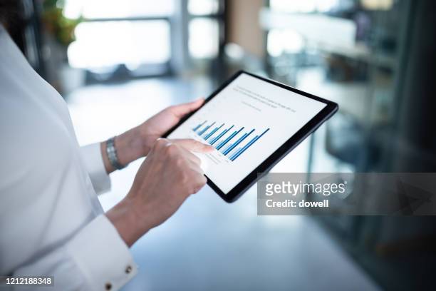 business report on digital tablet - strategia d'impresa foto e immagini stock
