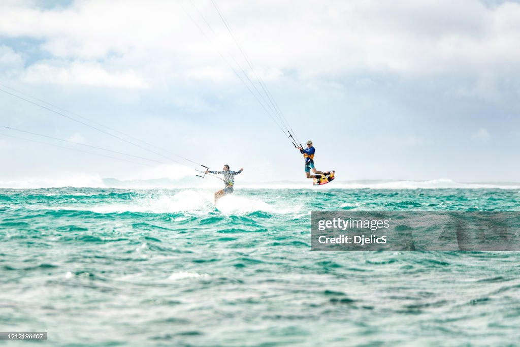 Two men kiteboarding together at Mauritius island