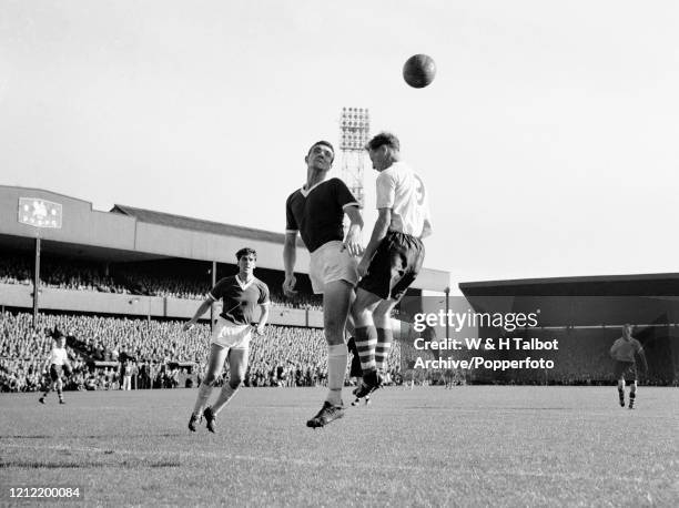 Bill Foulkes of Manchester United and Tom Finney of Preston North End compete in the air for the ball during a Football League Division One match at...