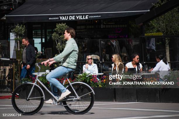 People sit in a restaurant in Stockholm on May 8 amid the coronavirus COVID-19 pandemic.