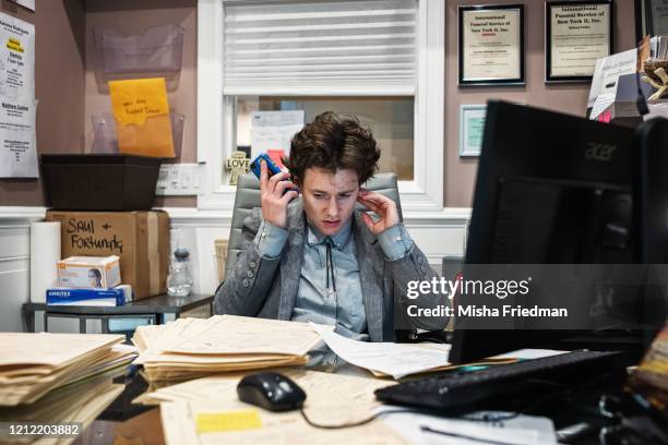Well into the night, Lily Sage Weinrieb speaks on the phone with relatives of a deceased on April 30, 2020 in New York City. After studying at the...