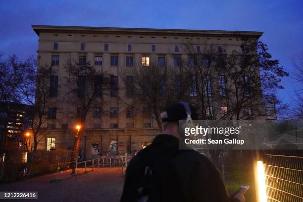 Man with headphones stands in front of the Berghain club, which is temporarily closed, on March 13, 2020 in Berlin, Germany. Berlin authorities are...