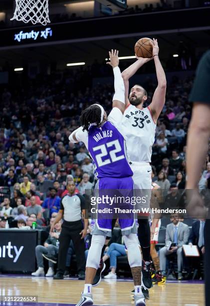 Marc Gasol of the Toronto Raptors shoots over Richaun Holmes of the Sacramento Kings during the second half of an NBA basketball game at Golden 1...
