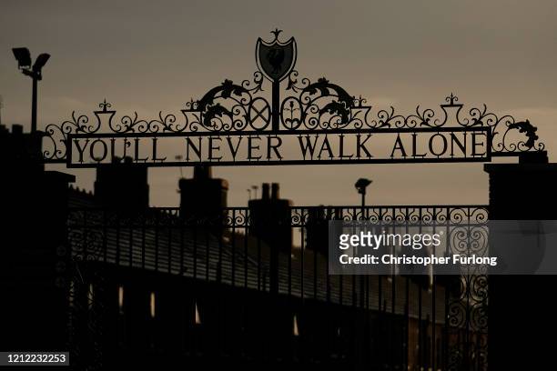 Dusk falls over The Shankly Gates at the home of Liverpool Football Club on March 13, 2020 in Liverpool, United Kingdom. It has been announced that...