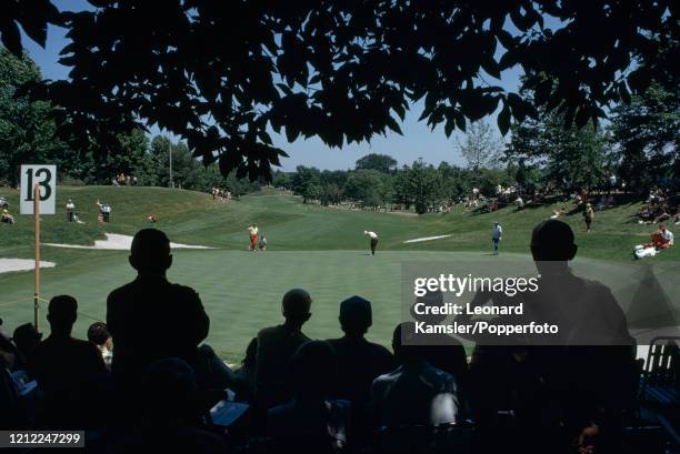 Putting action on the 13th green during the US Open Golf Championship on the East Course of the Oak Hill Country Club in Rochester, New York, circa...