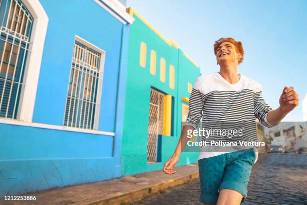redhead boy strolling on the street - olinda stock pictures, royalty-free photos & images