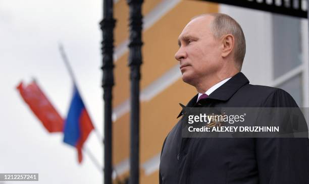 Russian President Vladimir Putin looks at military aircrafts flying over the Kremlin and Red Square to mark the 75th anniversary of the victory over...