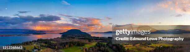 panoramic moonrise over lummi island, washington. - mount vernon stock pictures, royalty-free photos & images