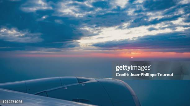 sunrise from an airplane, flying to asia - high section stock pictures, royalty-free photos & images