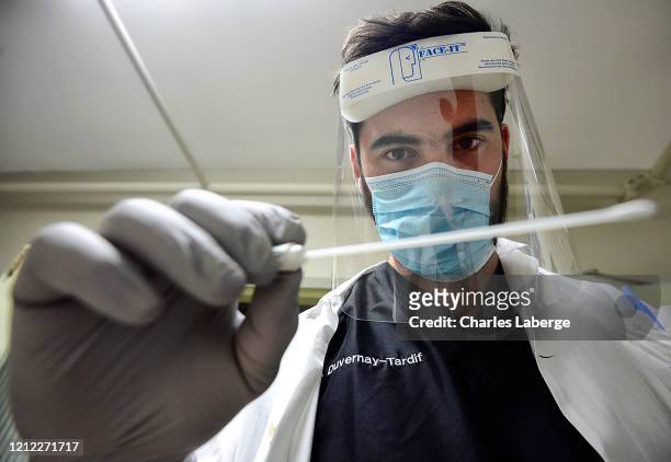 Closeup portrait of Kansas City Chiefs offensive guard Laurent Duvernay-Tardif holding swab during photo shoot at longterm care facility....