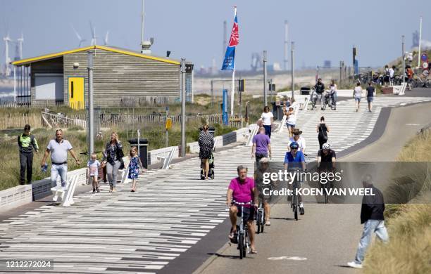 Day trippers enjoy the seaside at Zandvoort, a Dutch coastal town west of Amsterdam, on May 9 as the Dutch railway company NS called on people to...