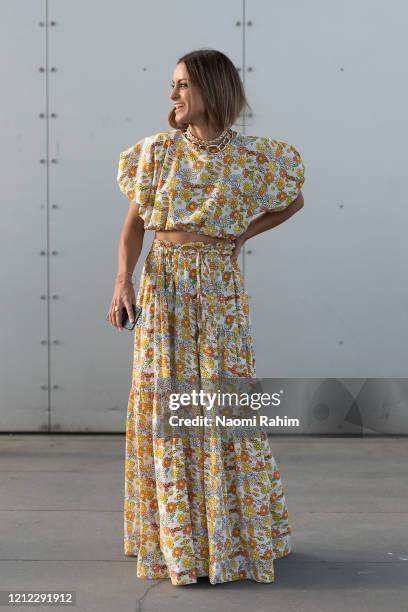 Guest poses in a floral dress ahead of Runway 1 at Melbourne Fashion Festival on March 11, 2020 in Melbourne, Australia.