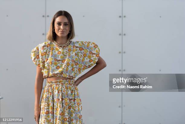 Guest poses in a floral dress ahead of Runway 1 at Melbourne Fashion Festival on March 11, 2020 in Melbourne, Australia.