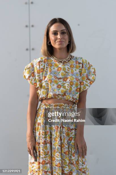 Guest poses in a floral dress ahead of Runway 1 at Melbourne Fashion Festival on March 11, 2020 in Melbourne, Australia.