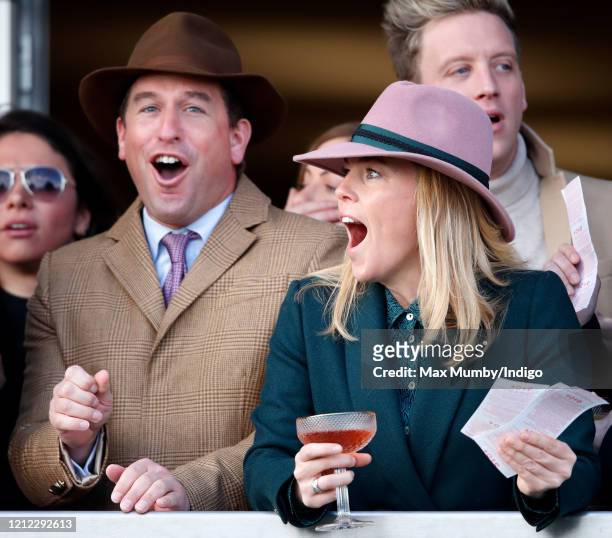 Peter Phillips and Autumn Phillips react as they watch the racing on day 4 'Gold Cup Day' of the Cheltenham Festival 2020 at Cheltenham Racecourse on...