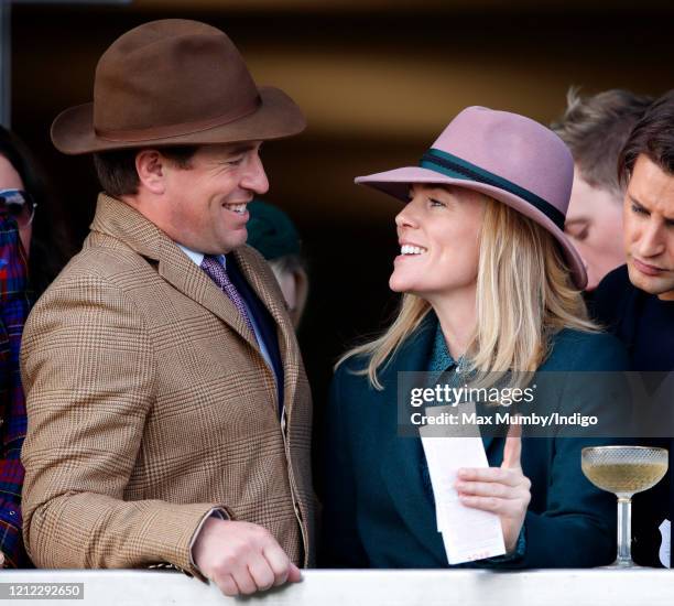 Peter Phillips and Autumn Phillips watch the racing as they attend day 4 'Gold Cup Day' of the Cheltenham Festival 2020 at Cheltenham Racecourse on...