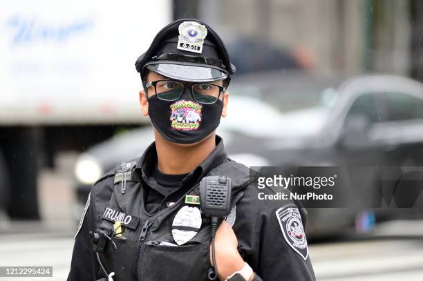 Transit Police officer wears a face mask in Center City Philadelphia, PA on May 8, 2020. About a dozen vehicles participate in a anti-quarantine and...