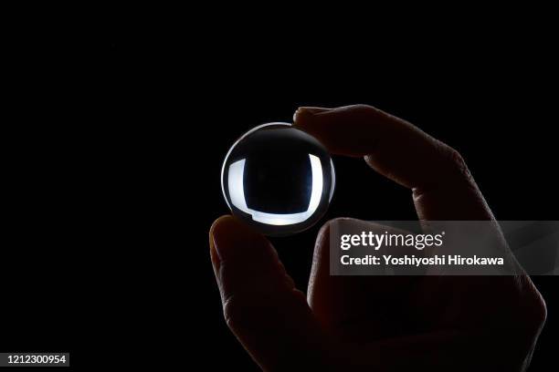 silhouette of hand with crystal - lens eye stock pictures, royalty-free photos & images