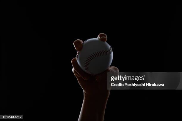 silhouette of hand with baseball ball - baseball ball ストックフォトと画像