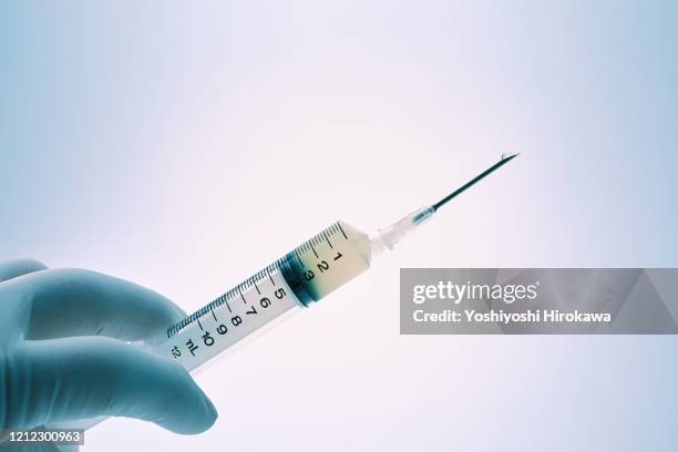 close-up of doctor's hand with syringe - injection stock pictures, royalty-free photos & images