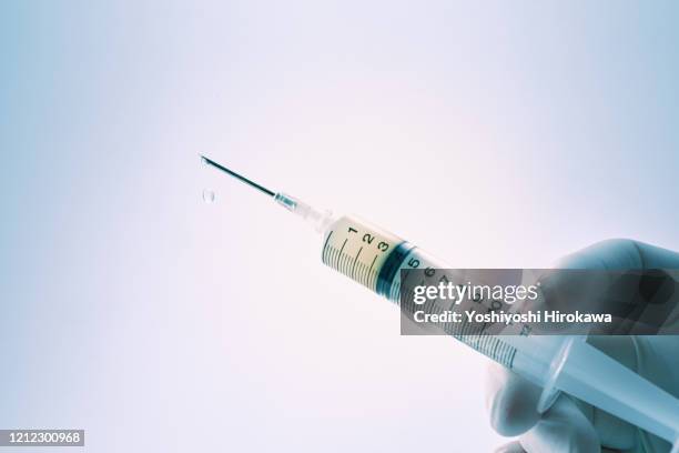 close-up of doctor's hand with syringe - sewing needle stock pictures, royalty-free photos & images
