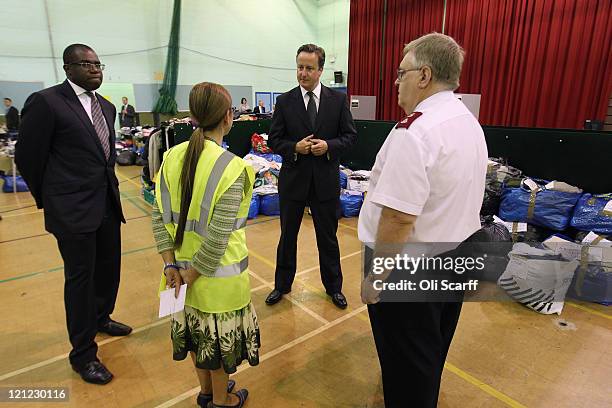 British Prime Minister David Cameron visits the Community Assistance Centre in Tottenham Green Leisure Centre with local MP David Lammy on August 16,...