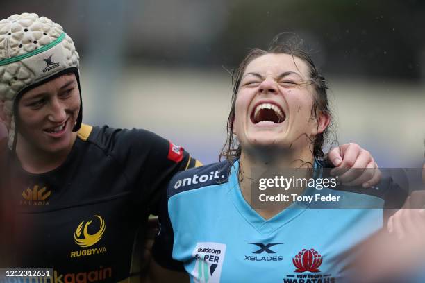 Grace Hamilton of the Waratahs and Katie Barnes of Western Australia at the finish of the game during the round five SuperW Rugby match between New...