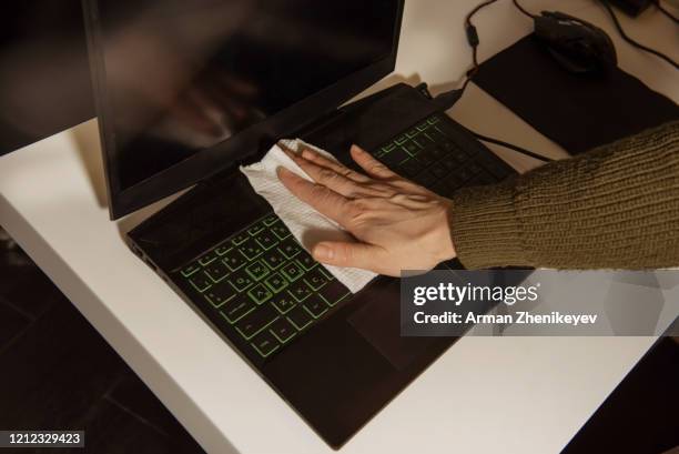 woman in office wiping keyboard by disposable facial tissue paper - papiertaschentuch stock-fotos und bilder