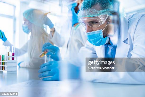 male scientist working on scientific research in laboratory. - science research stock pictures, royalty-free photos & images