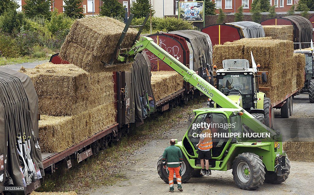 A telehandler loads bales of straw on a train on August 16, 2011 at ...