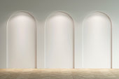 Empty bright gallery with three arches with a spotlight. Front view.