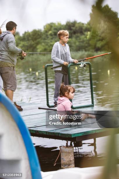 Happy Father And Son Fishing By The River High-Res Stock Photo - Getty  Images