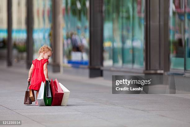 young girl walking with a bunch of bags - girl after shopping stock pictures, royalty-free photos & images