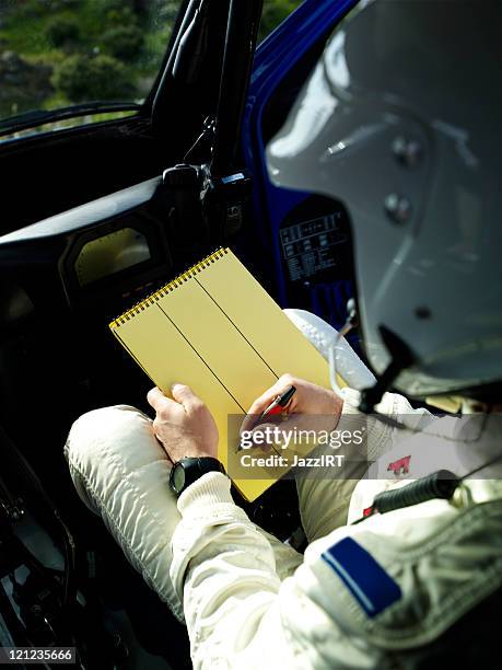 rally co-pilot writeing note - rally car stock pictures, royalty-free photos & images