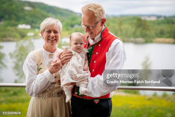 proud grandparents with their grandchild in bergen, norway - bunad stock pictures, royalty-free photos & images