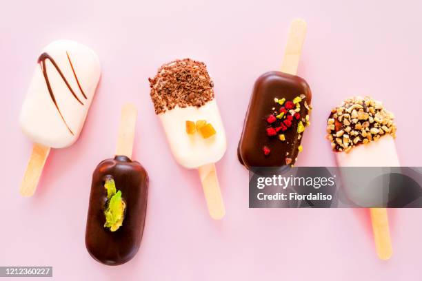 ice cream on a stick on a pink background. - bitter stock pictures, royalty-free photos & images