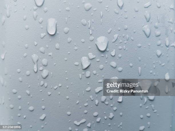 close-up of waterdrops on a clean, bent and plastic light gray surface - wet hose ストックフォトと画像