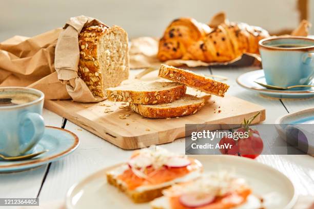 slices of bread among other delights - breakfast table stock pictures, royalty-free photos & images