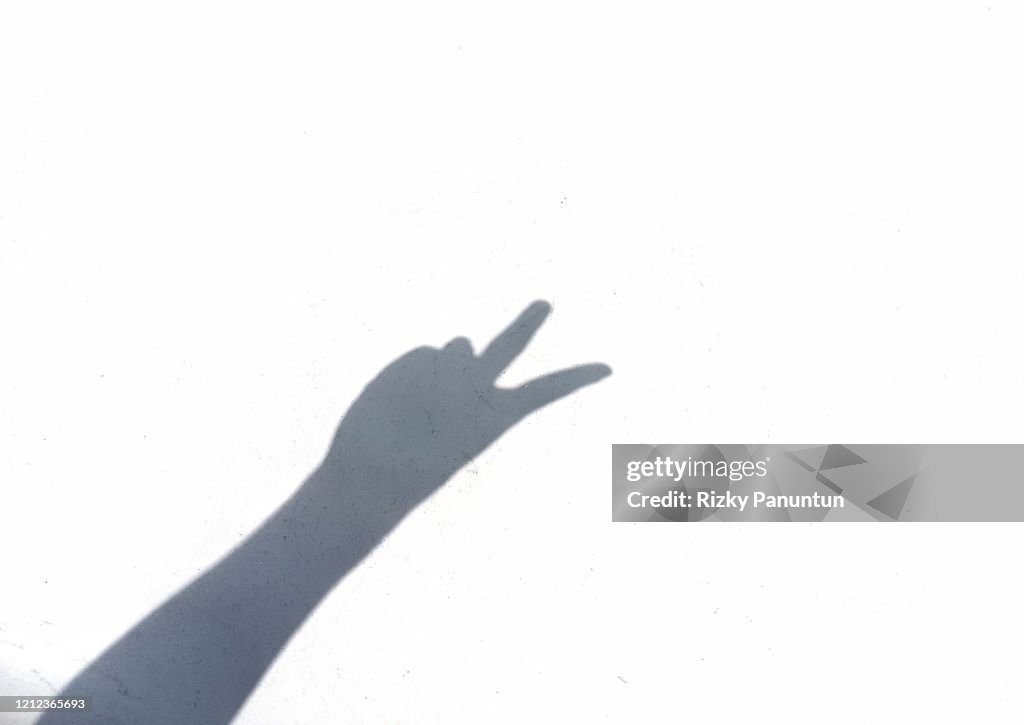 Shadow Person Sign Shadow Of Person Gesturing Peace Sign Seen On White Wall High-Res Stock ...