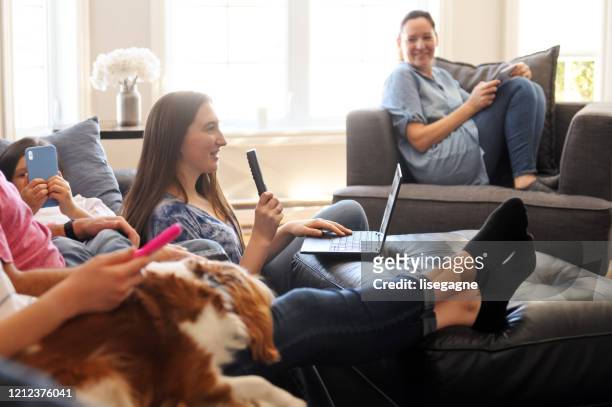 family watching tv and using internet - family tv pet stock pictures, royalty-free photos & images
