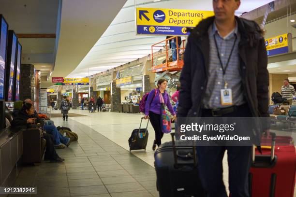 Passengers with a luggage trolley at Calgary Airport on November 17, 2014 in Calgary, Canada.