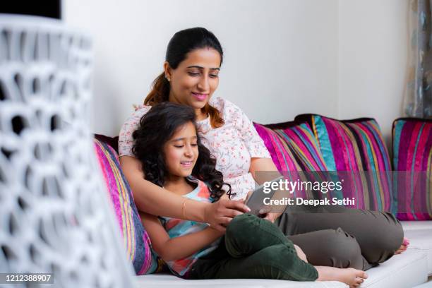 happy mom and daughter stock photo - indian mother and child stock pictures, royalty-free photos & images