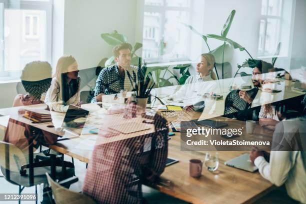 colleagues at business meeting in conference room. - design studio stock pictures, royalty-free photos & images