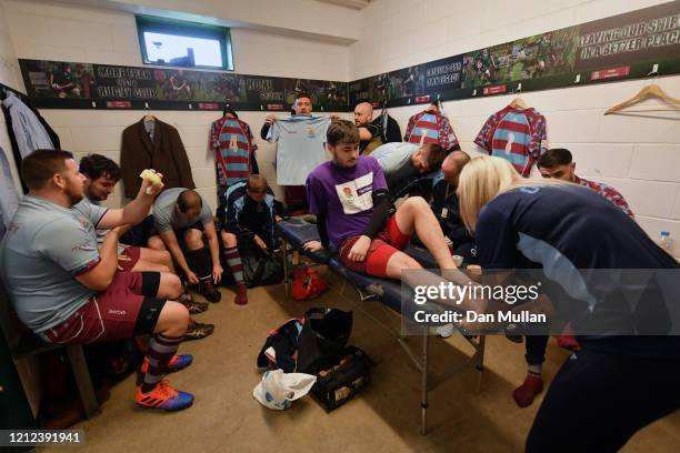 Ash Farr of OPMs has his ankle strapped prior to the Lockie Cup Semi Final match between Old Plymouthian and Mannameadians and Plymstock Albion Oaks...