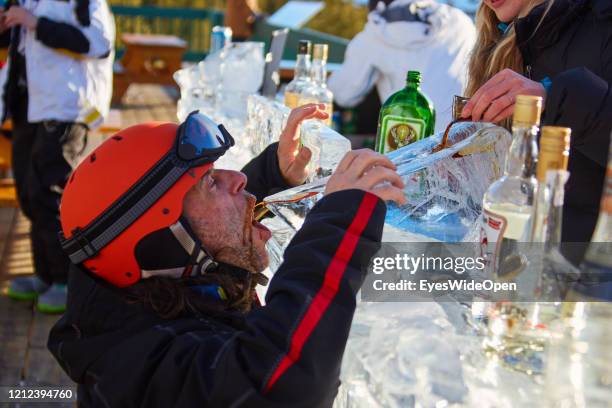 Skier is drinking Jaegermeister at an Ice Bar in Lake Louise Ski Resort on November 19, 2014 in Lake Louise, Canada.
