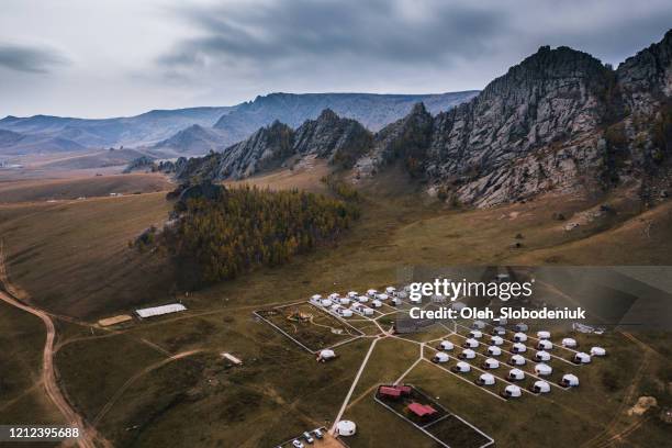 aerial view of nomadic village in mongolia at sunset - aerial top view steppe stock pictures, royalty-free photos & images