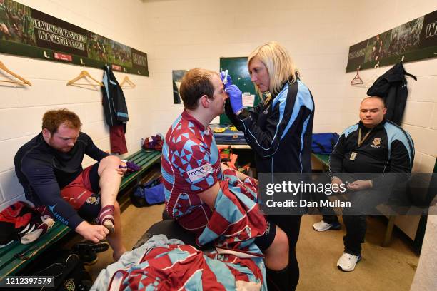 Mylo Connell of OPMs receives treatment to a head injury following the Lockie Cup Semi Final match between Old Plymouthian and Mannameadians and...