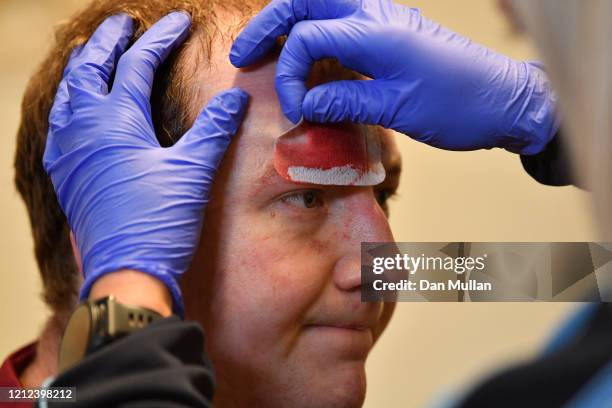 Mylo Connell of OPMs receives treatment to a head injury following the Lockie Cup Semi Final match between Old Plymouthian and Mannameadians and...